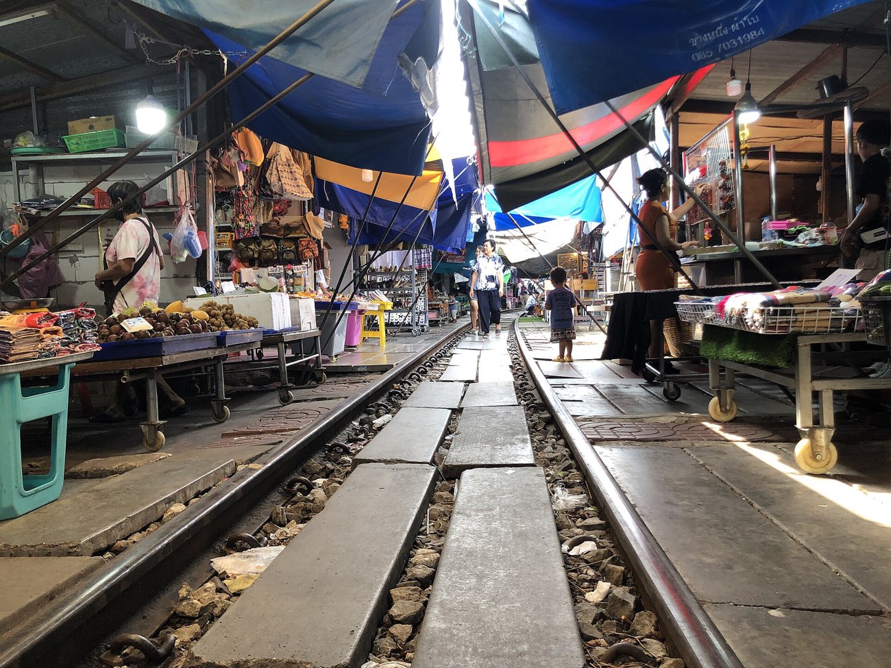 Market stalls crowding the train tracks at Maeklong Railway Market